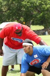 NFL offensive lineman Robert Hicks (left) pushes Ivanna Eudora Kean High School student Akram Solomon through his training. NFL offensive lineman Robert Hicks (left) pushes Ivanna Eudora Kean High School student Akram Solomon through his training.